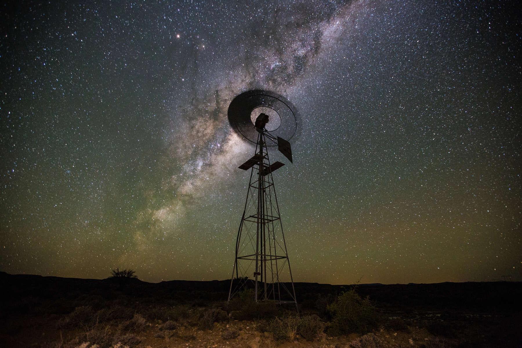 Close up image of a windpump / windmill /windpomp against a bright blue sky in the karoo of south africa 