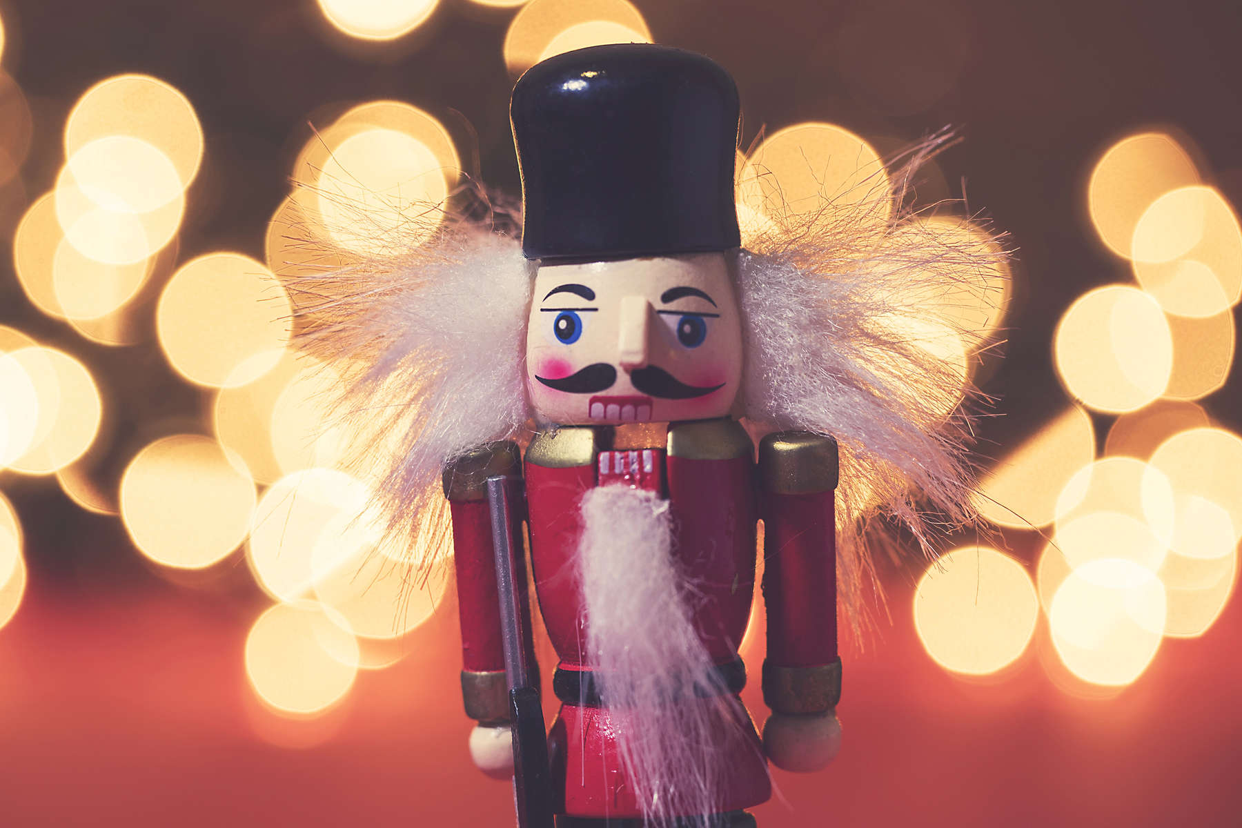 Festive nutcracker soldier with bokeh blurred fairy light